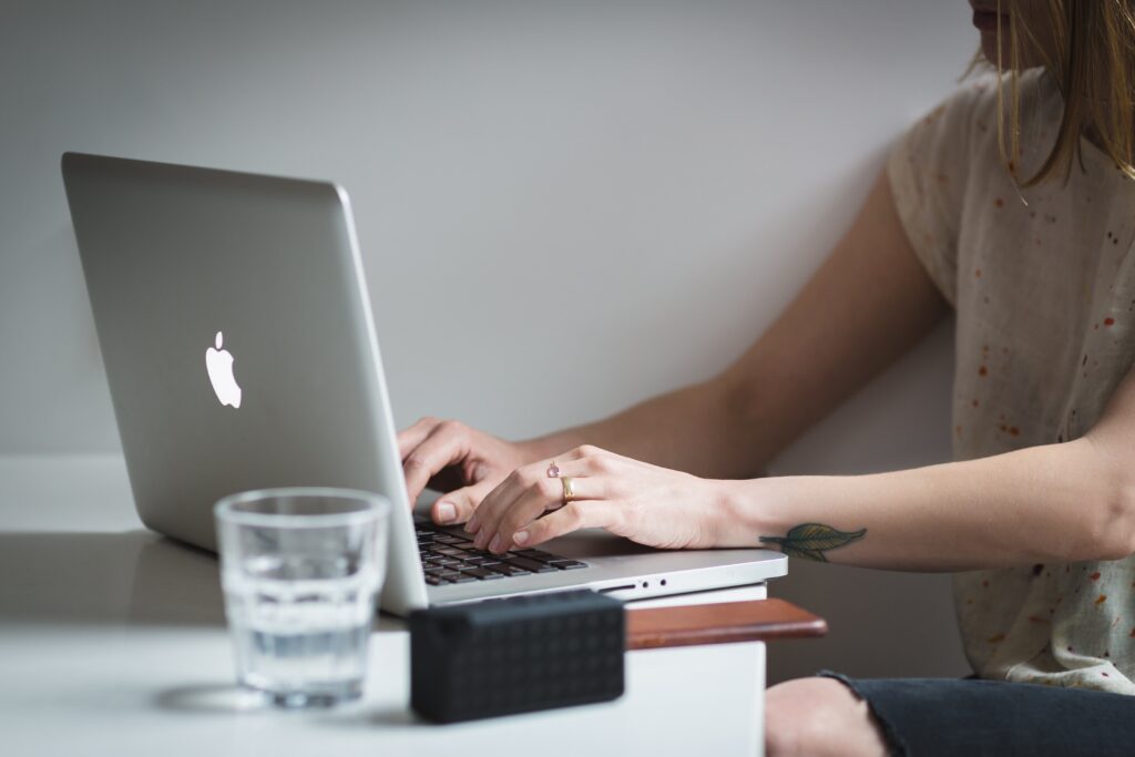a lady typing on a laptop